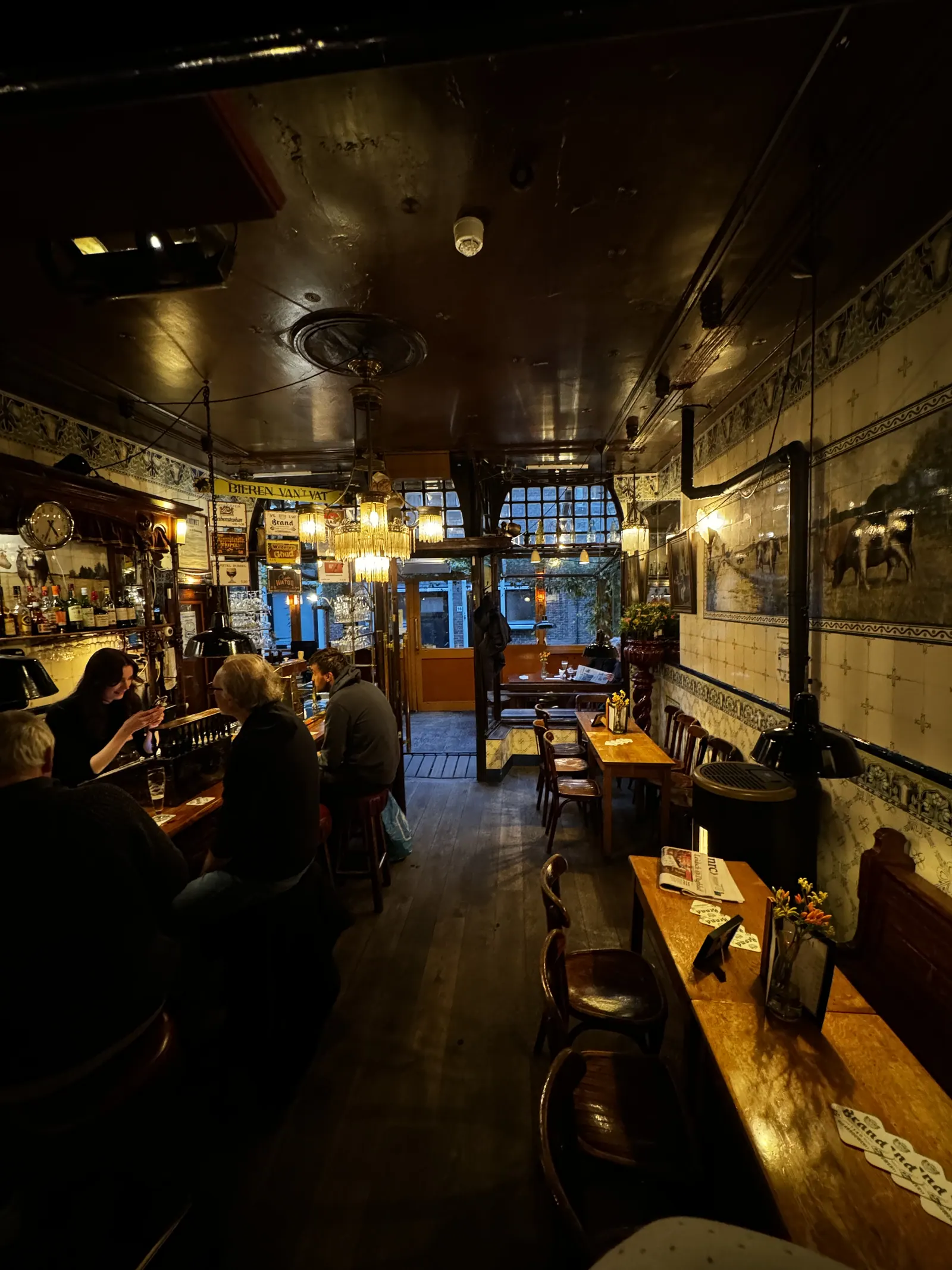 Warm interior of a traditional Leiden brown bar with wooden tables