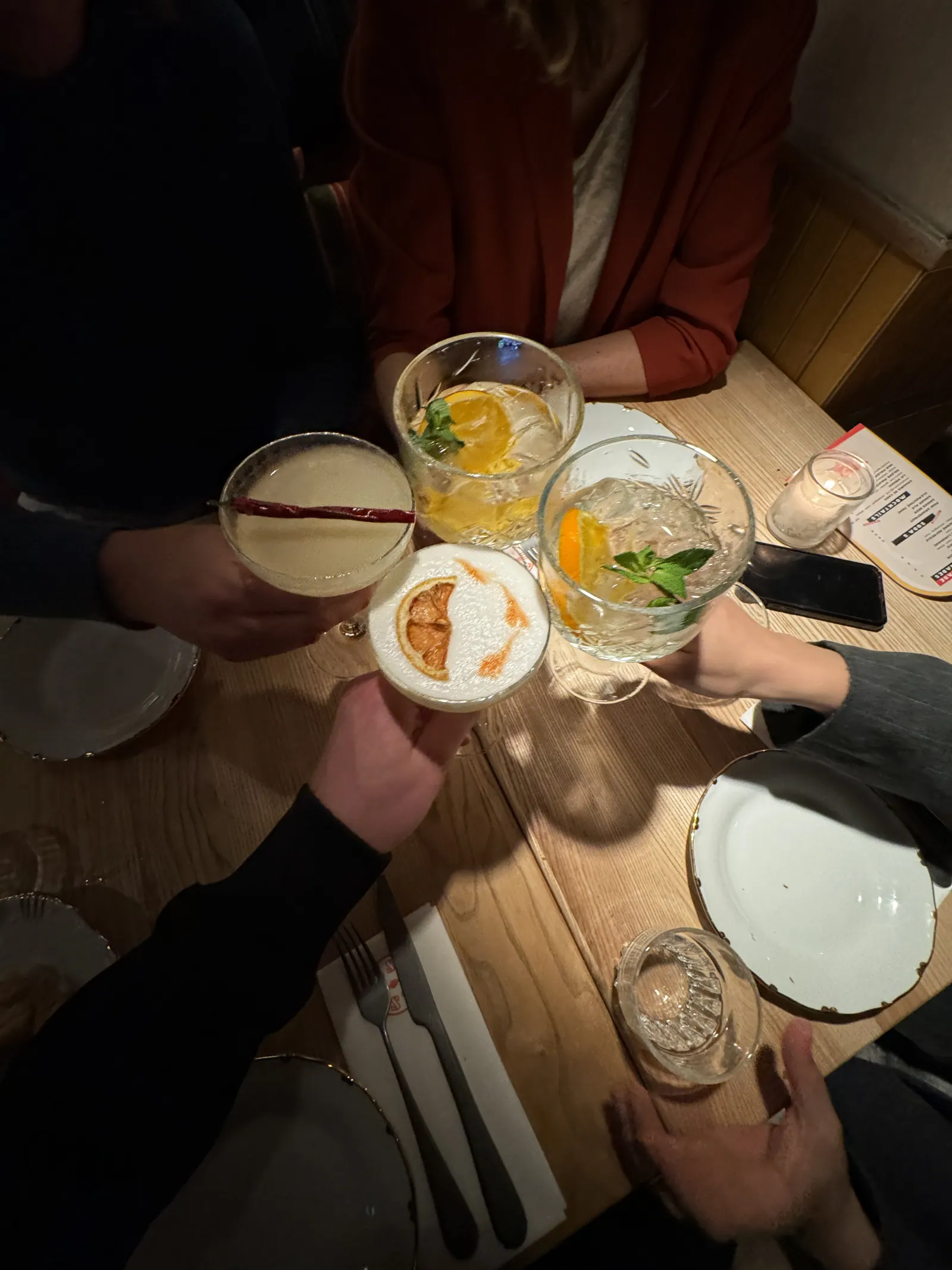 Toasting with cocktails at a table in a Leiden restaurant