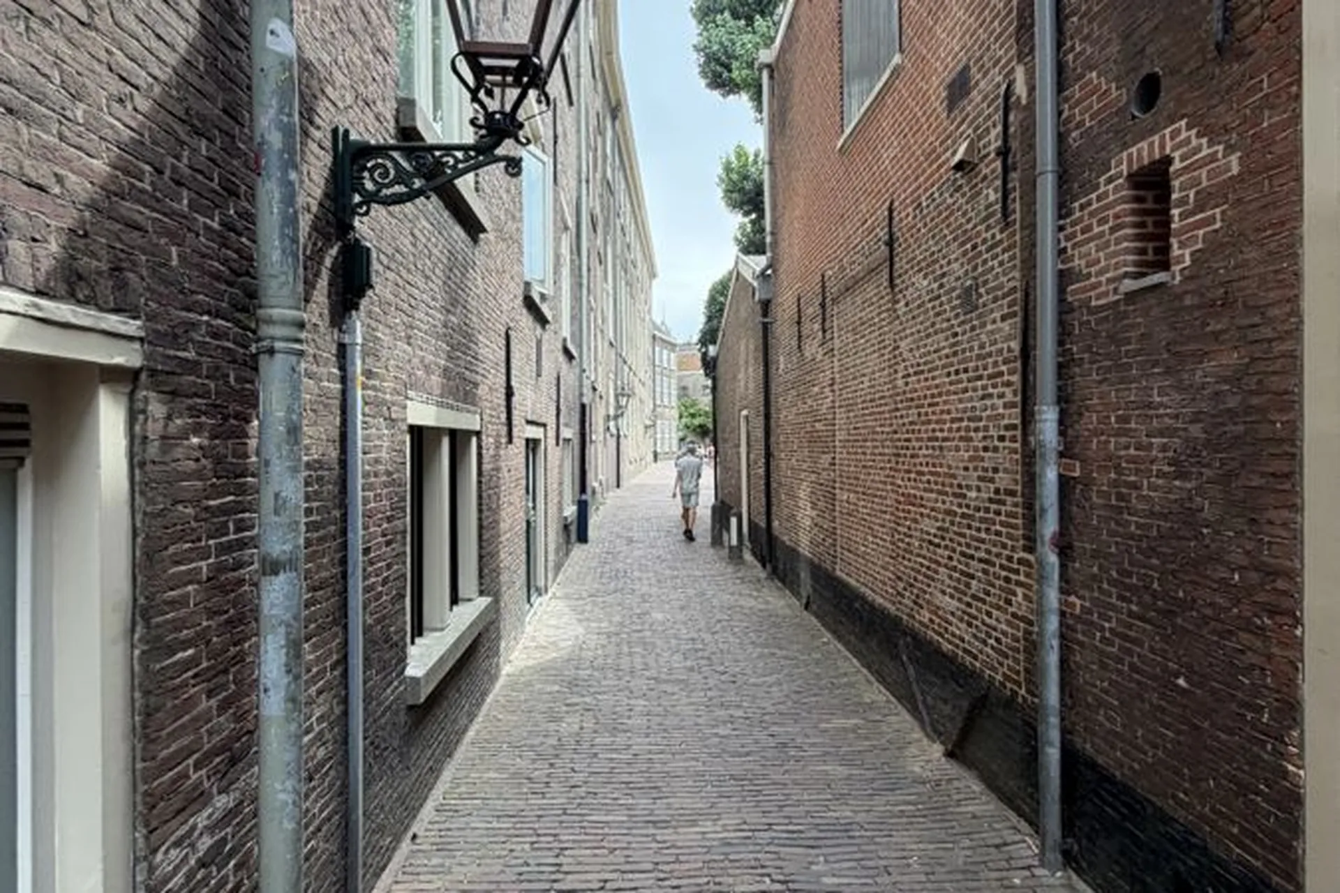 Narrow cobbled alley in Leiden with an old street lantern